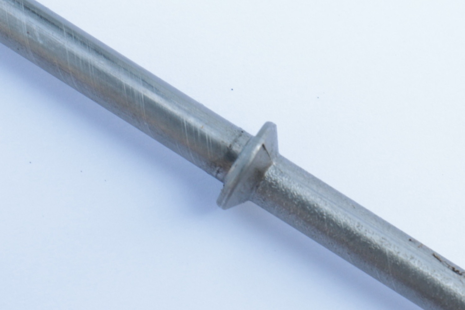 Close-up of a metal rod with an integrally formed raised collar